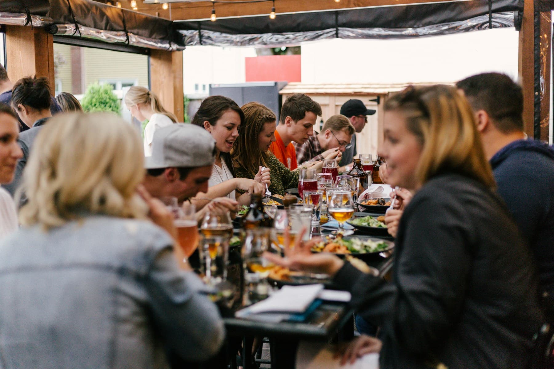 Friends sharing dinner around a long table